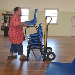 Zion Levy Stewart stacking the chairs at drama group in Brunswick Heads